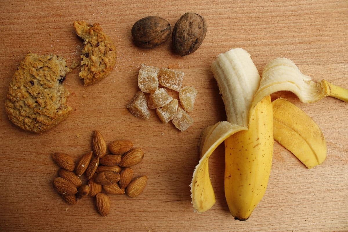 Sliced banana and mixed nuts arranged on a plate