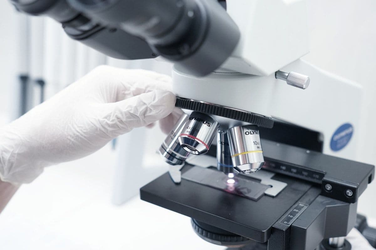 A researcher examining a specimen through a microscope