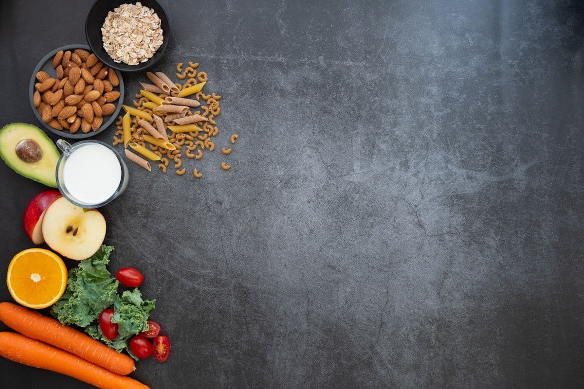 An assortment of fruit and vegetables on a dark table