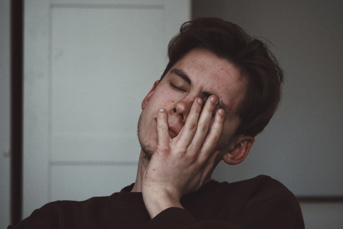 A man looking unwell, resting