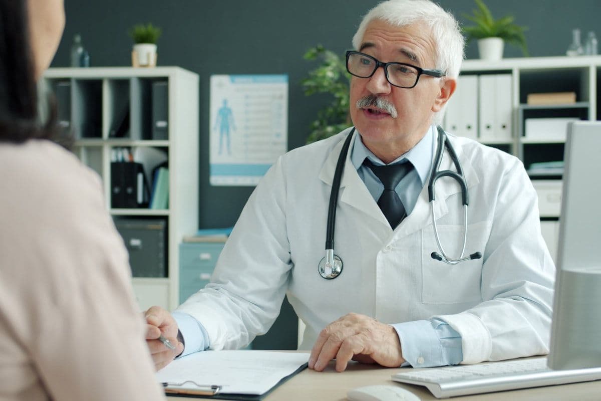 A clinician talking with a patient in a consulting room